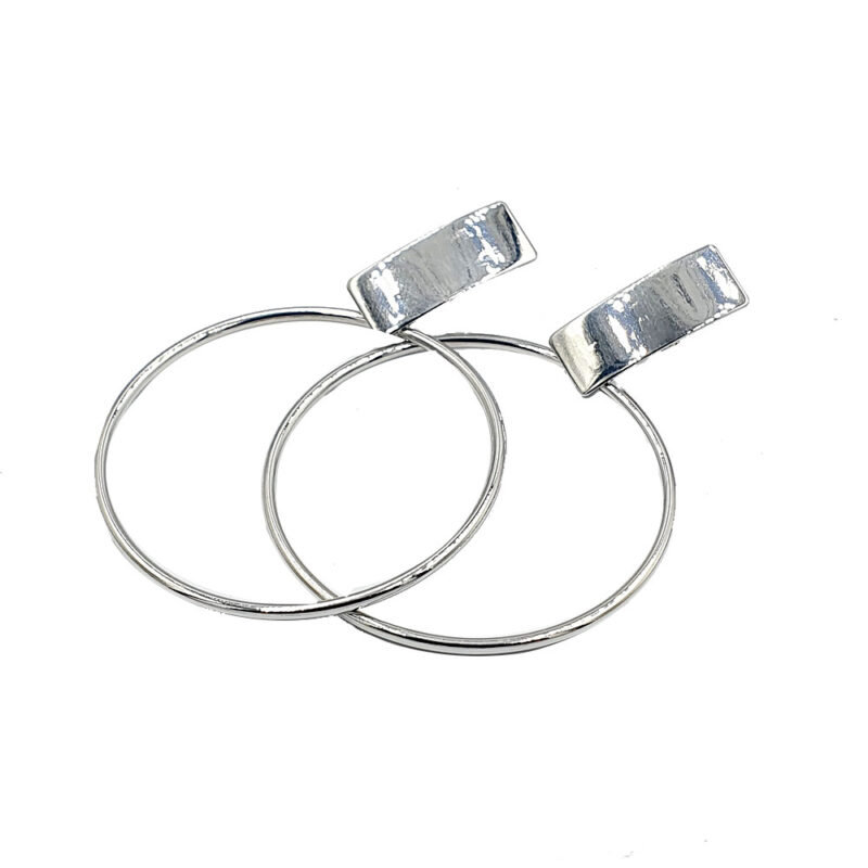 Pair of shiny silver hoop earrings with rectangular top clasps, overlapping slightly.