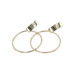 Pair of thin gold hoop earrings with clip-on metal clasps against a white background