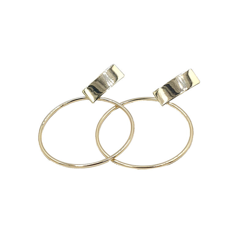 Pair of thin gold hoop earrings with clip-on metal clasps against a white background