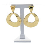 Gold-tone dangling earrings with irregular circular hoops on a display stand