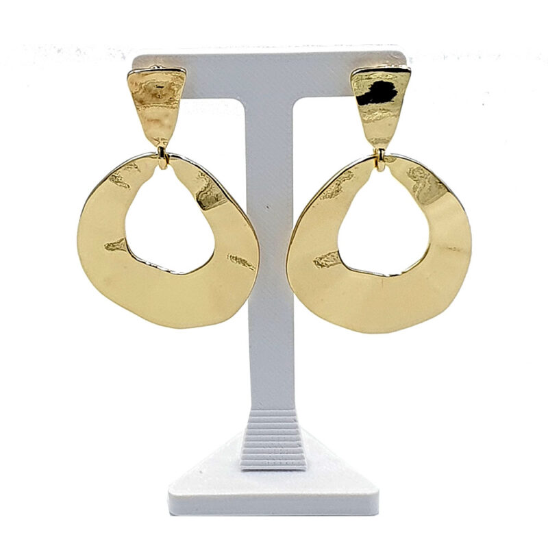 Gold-tone dangling earrings with irregular circular hoops on a display stand
