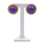 Purple cabochon stud earrings with gold twisted rope border on a white display stand