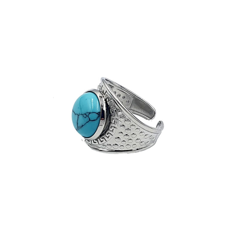 Silver ring with a turquoise oval stone featuring black veining, set in a decorative bezel.