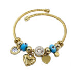 Gold-toned charm bracelet with blue beads and heart charms.