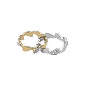 Two interlocking heart-shaped rings, one gold and one silver, with small crystal accents.