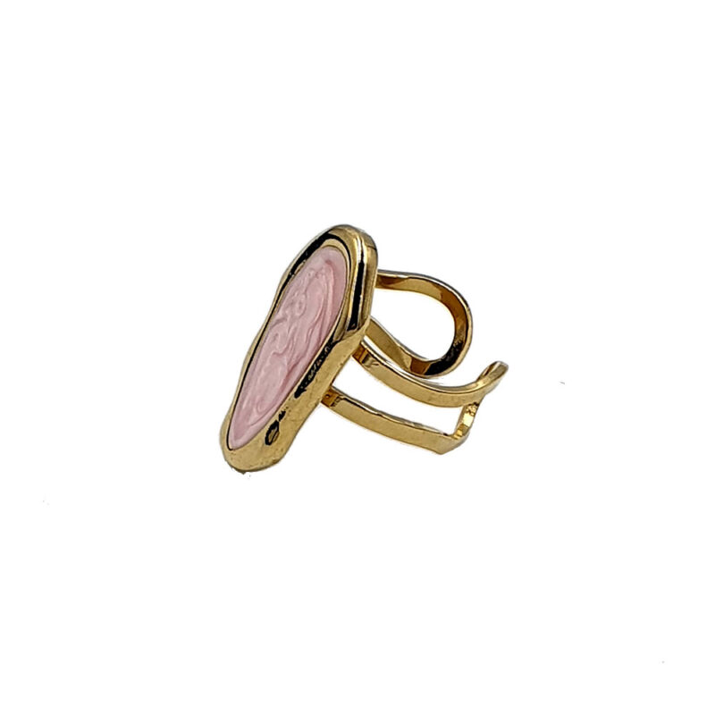 Gold ring featuring an oval pink marbled stone set in a bezel on an open adjustable band at an angle