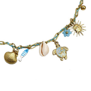 Gold-tone charm bracelet with ocean-themed charms: sun pendant, turtle, shell, fish, and small blue flower on a blue-gold chain (close-up).