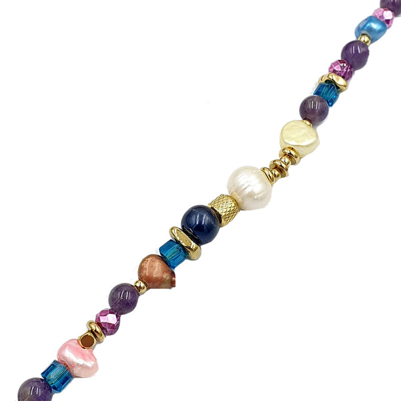 Colorful beaded necklace with purple, pink, blue beads and gold accents, laid diagonally across a white background