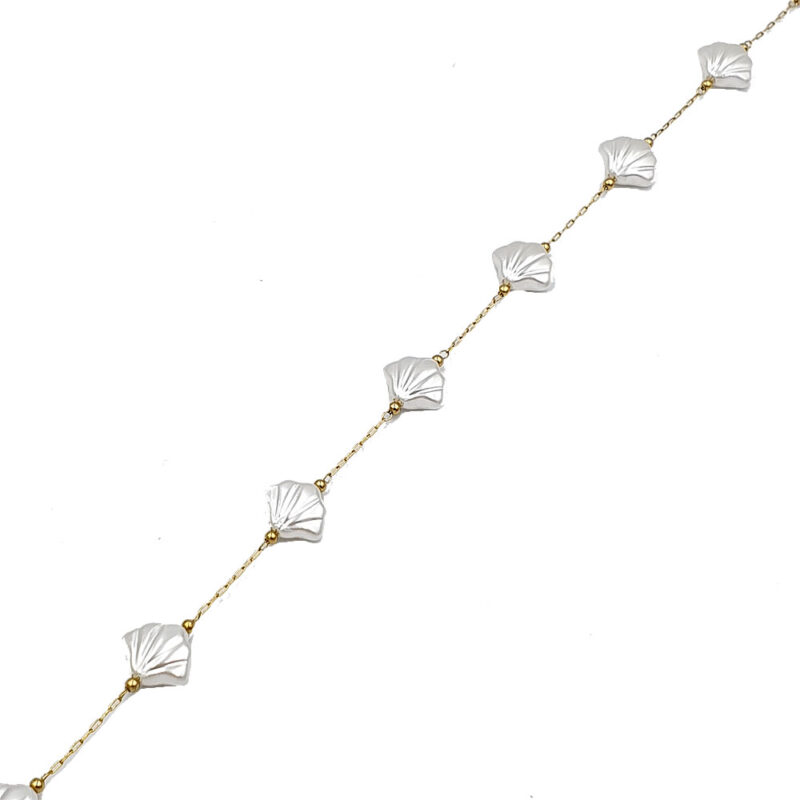 Delicate gold chain necklace with white shell-like beads spaced along the chain, shown diagonally on a white background.