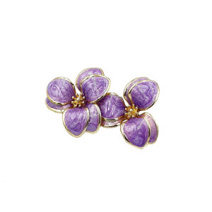 Purple flower-shaped jewelry brooch with gold-trimmed petals and small gold centers.