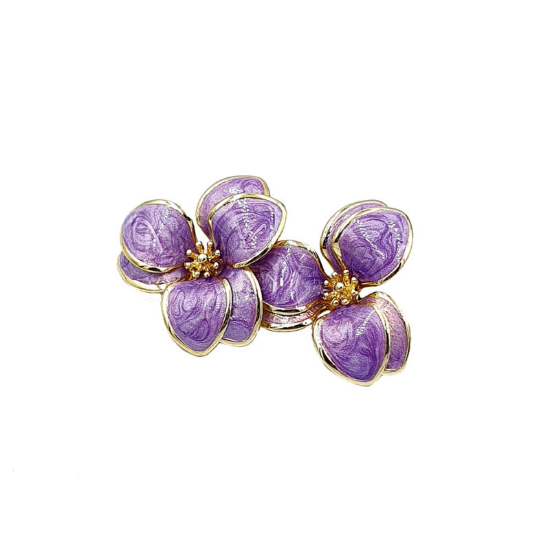 Purple flower-shaped jewelry brooch with gold-trimmed petals and small gold centers.
