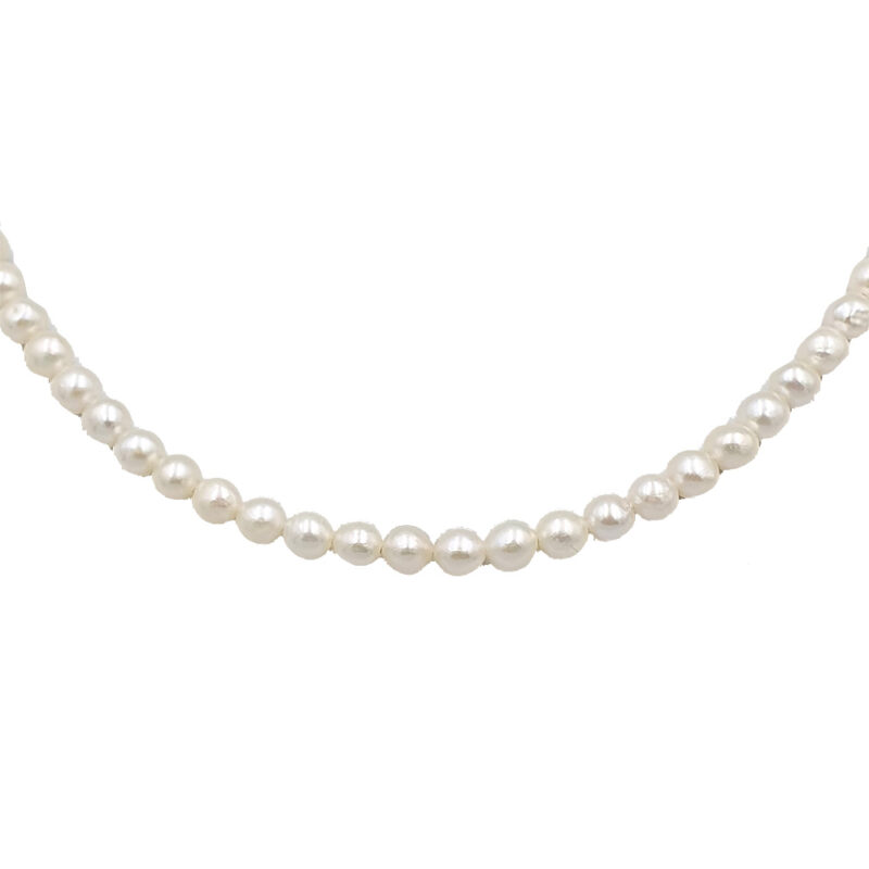 Strand of white pearls forming a curved necklace on a white background.