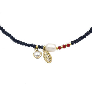 Beaded necklace with gold leaf charm, a pearl bead, and red and gold spacers on a black bead strand.