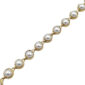 Gold-tone bracelet with round white pearls set in bezel links along a delicate chain