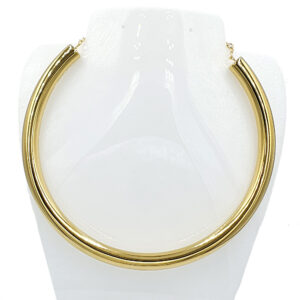 Gold curb chain necklace displayed on a white jewelry bust