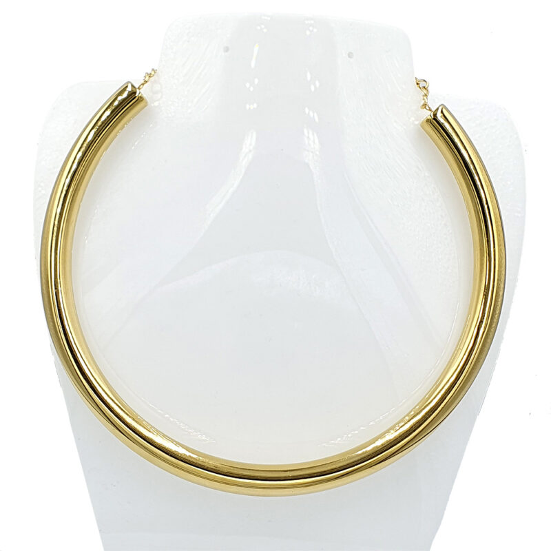 Gold curb chain necklace displayed on a white jewelry bust