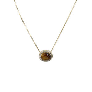 Gold chain necklace with oval tiger's eye gemstone surrounded by small diamonds on a halo pendant lens.