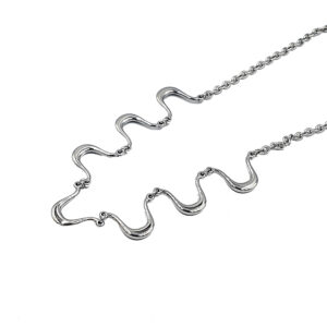Silver necklace with wavy, S-shaped links on a white background (close-up).