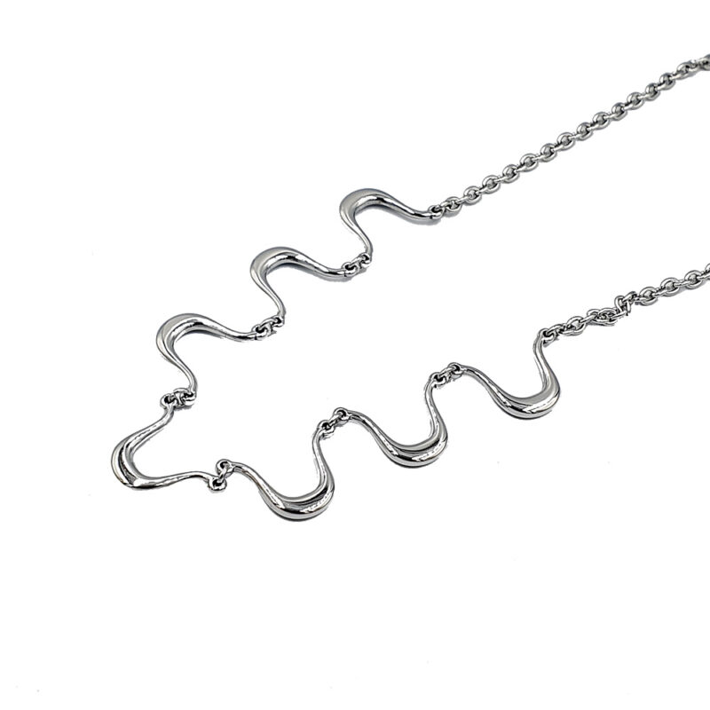 Silver necklace with wavy, S-shaped links on a white background (close-up).