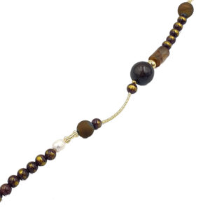 Beaded necklace with dark purple and gold marbled beads, a white pearl accent, and a small gold chain detail.