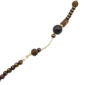Beaded necklace with dark purple and gold marbled beads, a white pearl accent, and a small gold chain detail.
