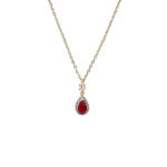 Gold chain necklace with a teardrop red gemstone pendant surrounded by small clear stones and a tiny diamond above, on a white background.