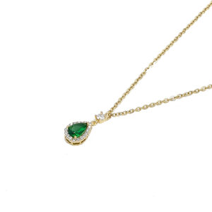 Gold necklace with a teardrop green gemstone pendant surrounded by small diamonds on a delicate chain