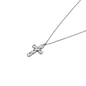 Silver necklace with a diamond-studded cross pendant on a delicate chain photographed on white background
