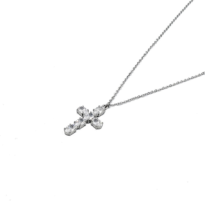 Silver necklace with a diamond-studded cross pendant on a delicate chain photographed on white background
