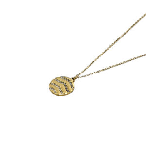 Gold pendant necklace with a circular striped design encrusted with small crystals on a thin chain.