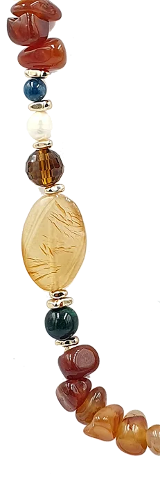 Multi-colored beaded necklace with red stones, a blue bead, white pearl, amber centerpiece, and brown beads on a string.